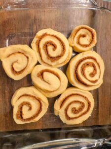 Cinnamon roll dough cut into 1 inch rolls and in a baking dish
