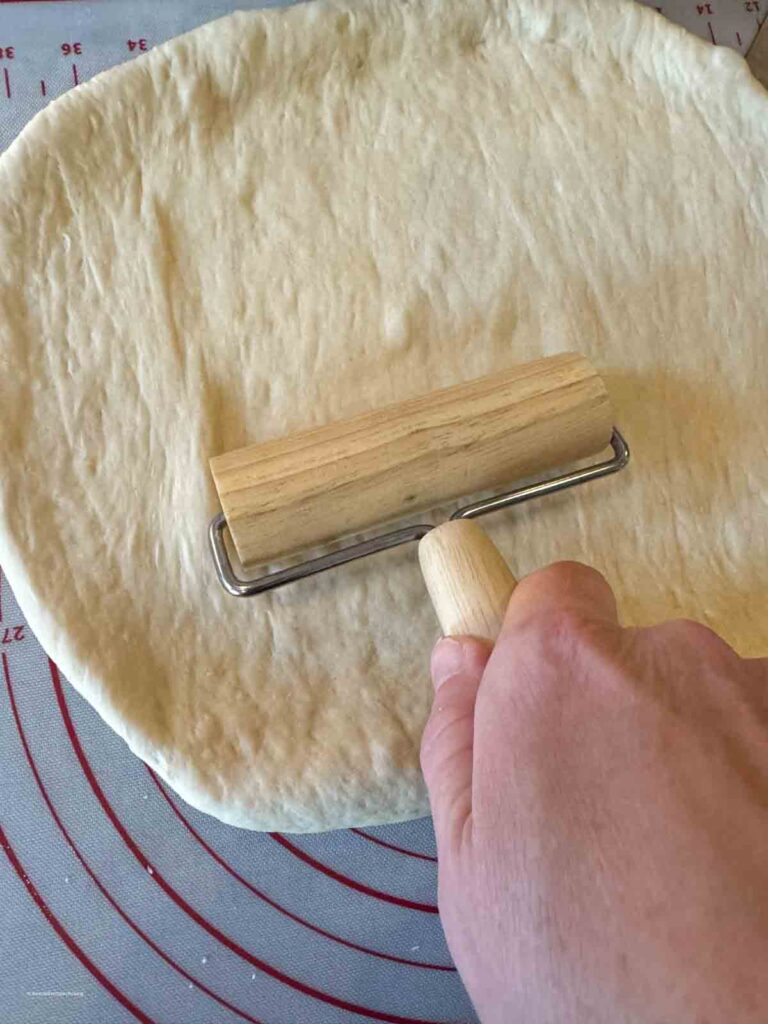 rolling out homemade cinnamon roll dough